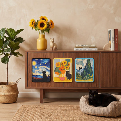 Three decorative art prints featuring Van Gogh-inspired designs (Starry Night, Sunflowers with a cat, and a blue landscape) displayed on a wooden cabinet in a cozy room setting with a cat resting in a bed nearby.